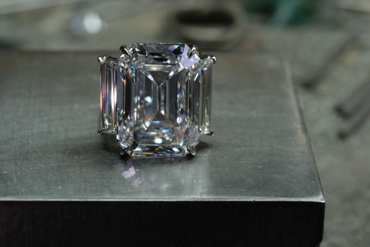 Platinum emerald-cut diamond ring with tapered baguette side stones, front view