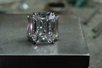 Platinum emerald-cut diamond ring with tapered baguette side stones, front view