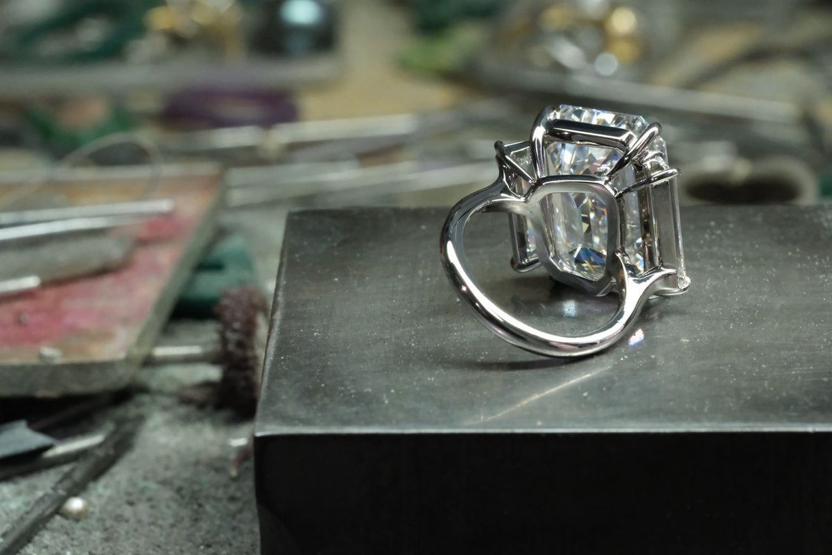 Platinum emerald-cut diamond ring with tapered baguette side stones, reverse view