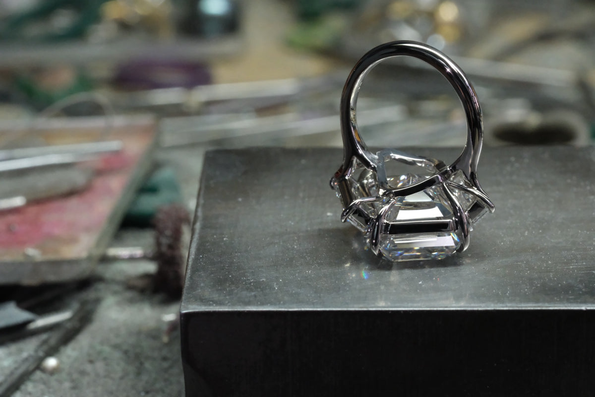 Platinum emerald-cut diamond ring with tapered baguette side stones, underside view