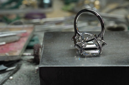 Platinum emerald-cut diamond ring with tapered baguette side stones, underside view
