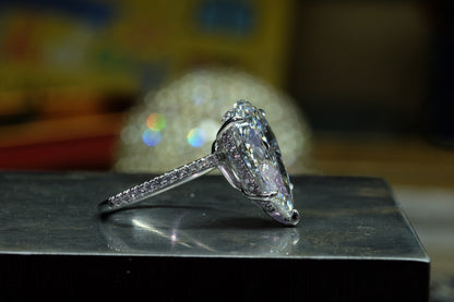 Offset Pear Diamond Solitaire Ring, side view with hidden pavé halo