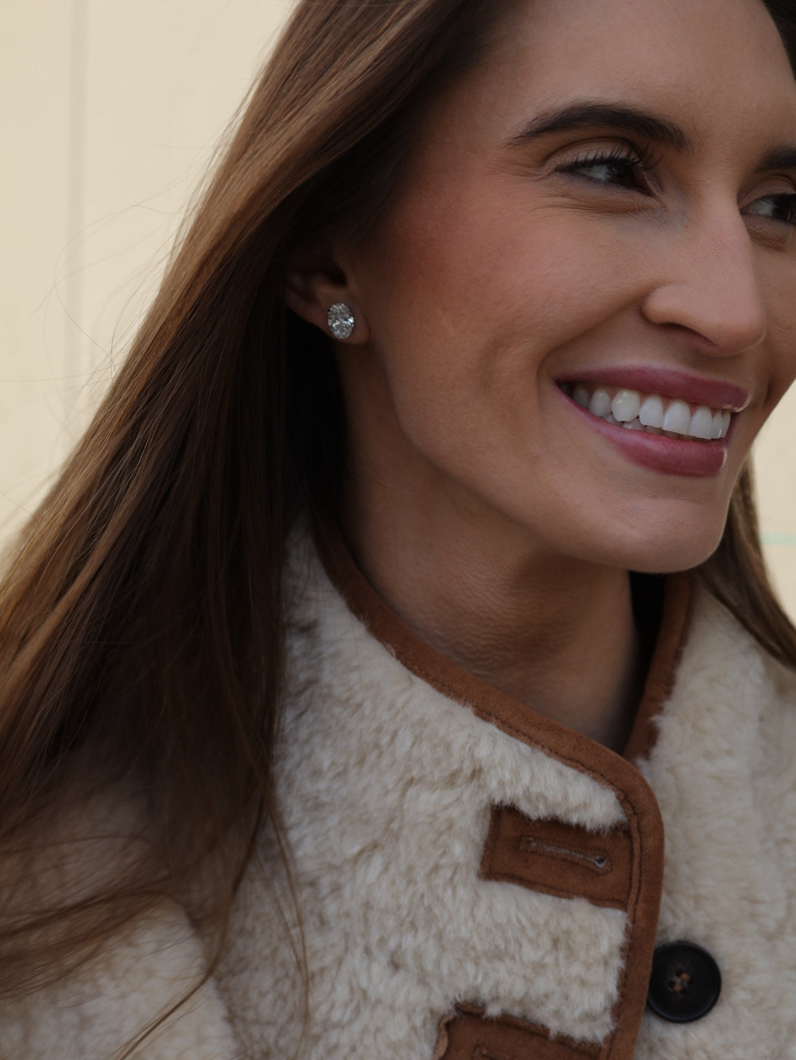Oval diamond stud earring worn on the ear