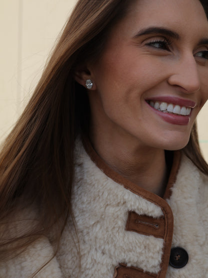 Oval diamond stud earring worn on the ear