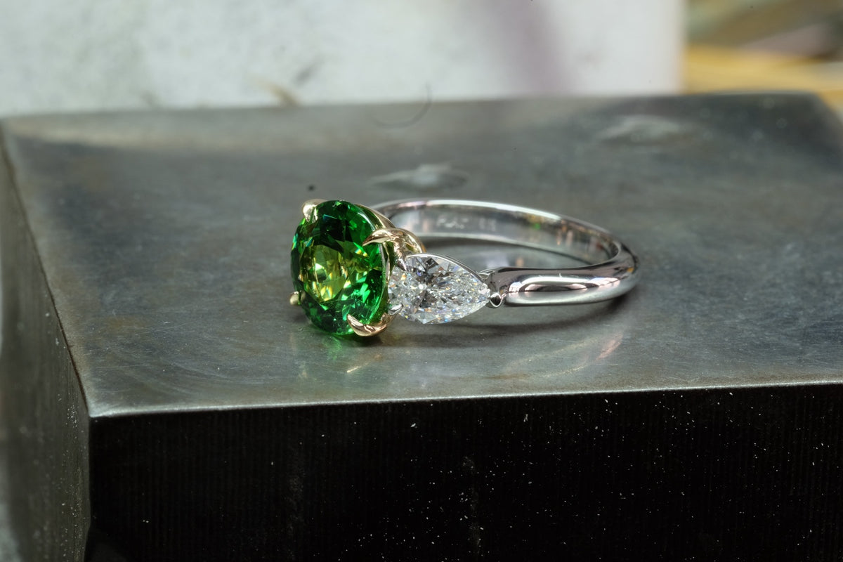 Oval Emerald & Pear Diamond Three-Stone Ring, angled view