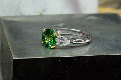 Oval Emerald & Pear Diamond Three-Stone Ring, angled view