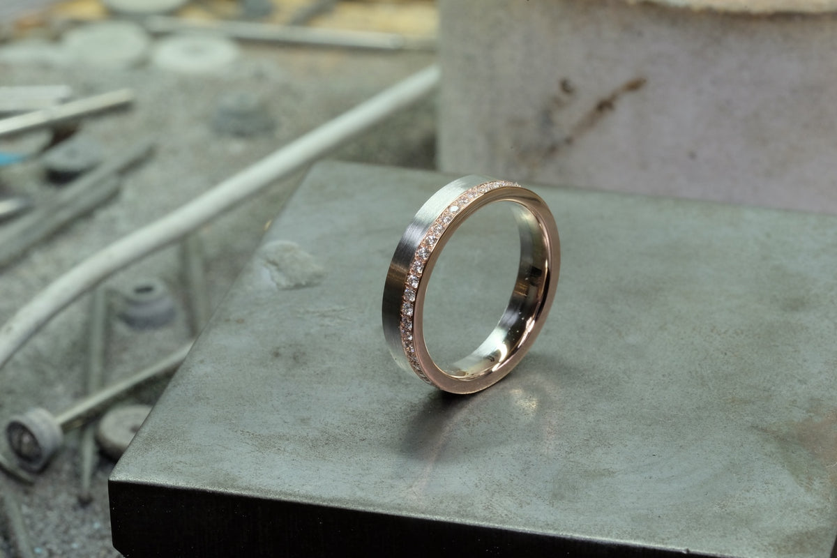 Platinum & Rose Gold Union Bands, diamond band angled view