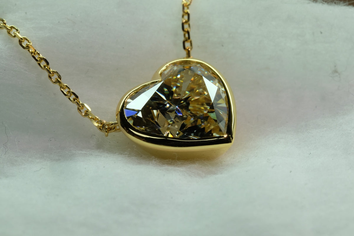 Yellow diamond heart pendant in 18k yellow gold, close-up detail