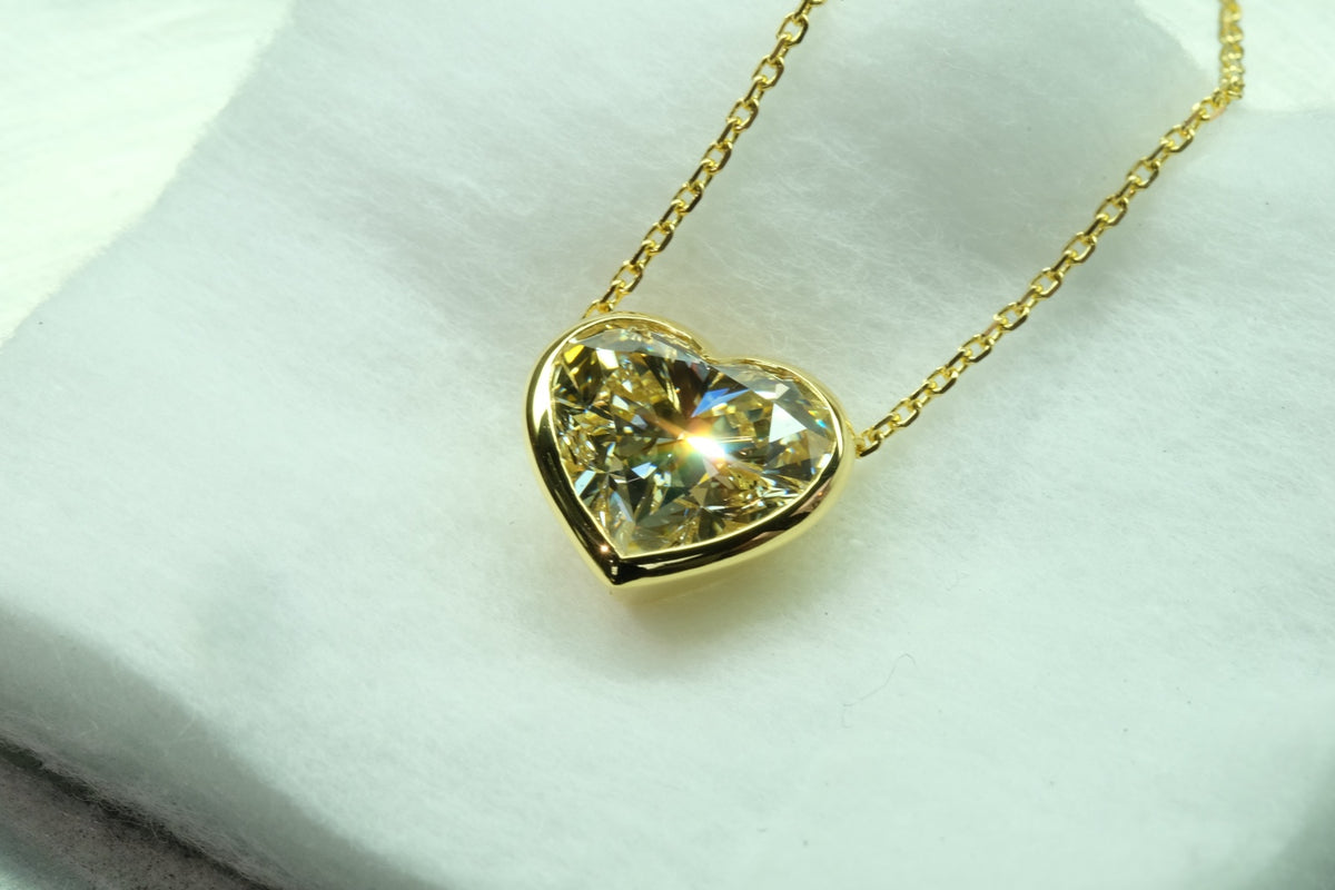 Yellow diamond heart pendant in 18k yellow gold, front view
